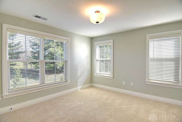 9460 Banyan Ct, Centerville, OH 45458 - empty room featuring plenty of natural light, baseboards, visible vents, and light carpet