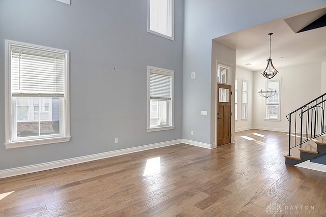 9460 Banyan Ct, Centerville, OH 45458 - entryway with stairway, a healthy amount of sunlight, wood finished floors, and a chandelier