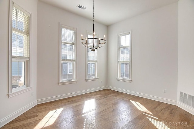 9460 Banyan Ct, Centerville, OH 45458 - unfurnished dining area featuring baseboards, wood finished floors, visible vents, and a chandelier