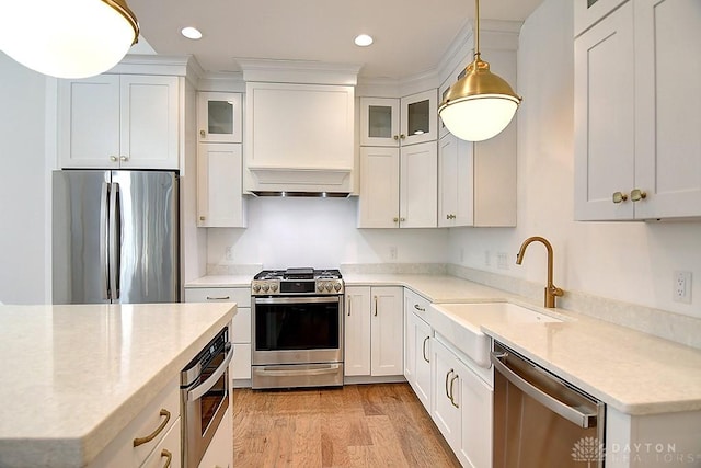 9460 Banyan Ct, Centerville, OH 45458 - kitchen with a sink, white cabinets, hanging light fixtures, and stainless steel appliances