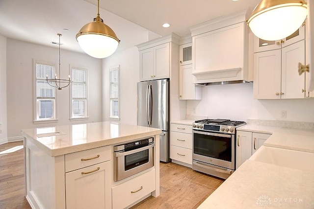 9460 Banyan Ct, Centerville, OH 45458 - kitchen with custom exhaust hood, white cabinets, appliances with stainless steel finishes, and light wood-style floors