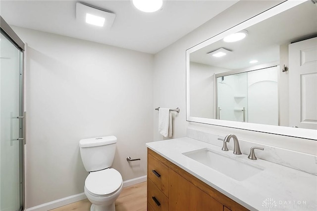 bathroom with vanity, toilet, an enclosed shower, and wood-type flooring