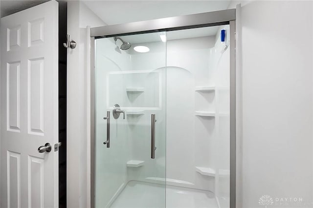 bathroom with a shower with shower door