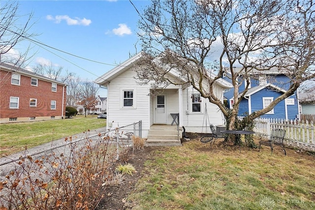 back of house with a lawn