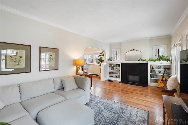 living room with ornamental molding and hardwood / wood-style floors