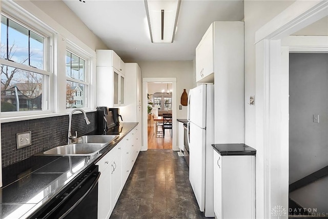 kitchen with dishwashing machine, sink, white cabinets, and white refrigerator