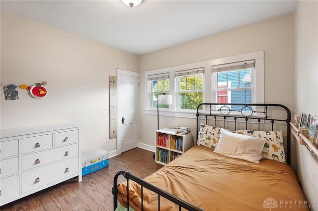 bedroom with hardwood / wood-style floors