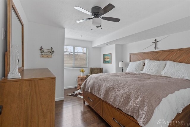 bedroom featuring ceiling fan and dark hardwood / wood-style flooring