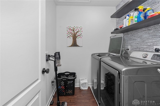 washroom with washing machine and dryer and dark hardwood / wood-style floors