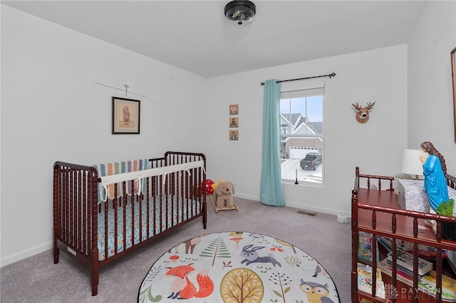 carpeted bedroom with a crib