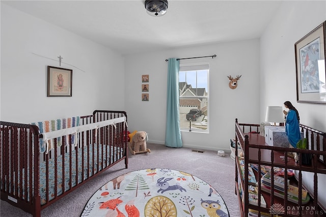 carpeted bedroom with a crib