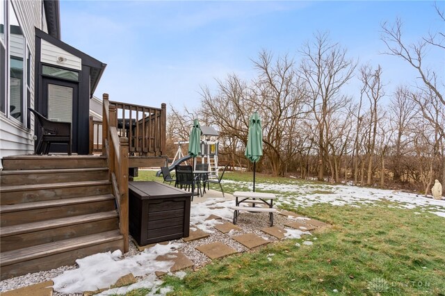 snowy yard with a playground