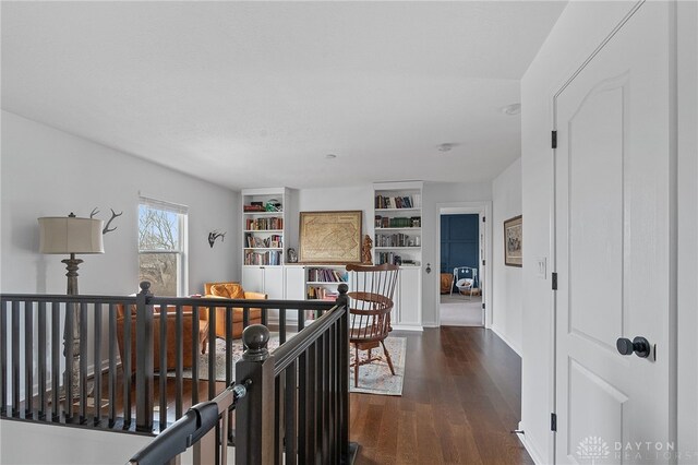 corridor with dark hardwood / wood-style flooring