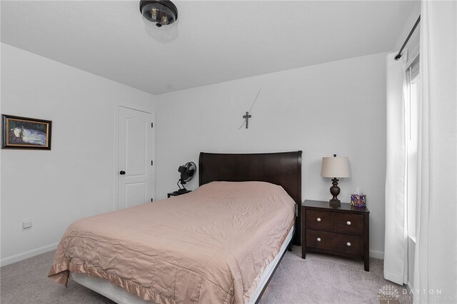 bedroom featuring light colored carpet