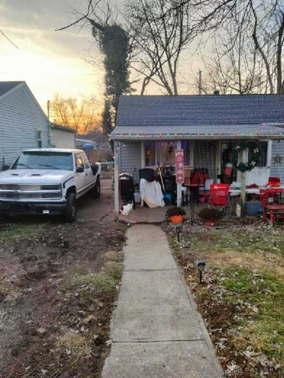 property exterior at dusk with covered porch