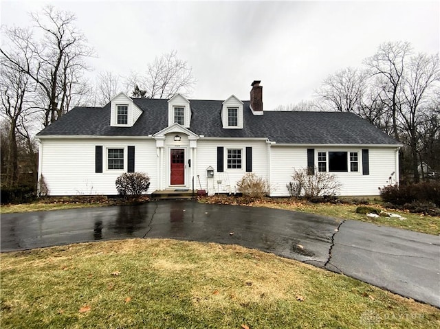 new england style home with a front lawn