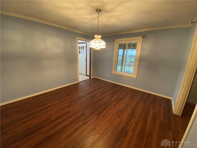 empty room featuring ornamental molding and dark hardwood / wood-style floors