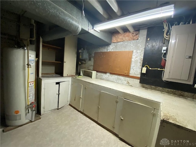 basement featuring electric panel and gas water heater