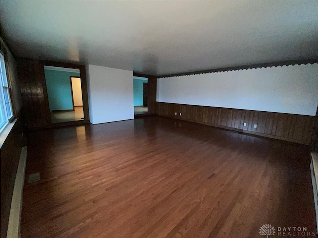 unfurnished room with dark hardwood / wood-style flooring