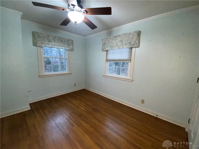 unfurnished room featuring dark hardwood / wood-style flooring, crown molding, and a wealth of natural light