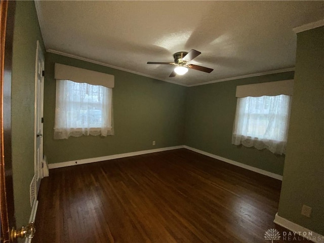 spare room featuring crown molding, ceiling fan, and dark hardwood / wood-style floors