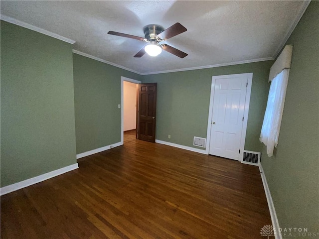 unfurnished bedroom with ornamental molding, dark wood-type flooring, and ceiling fan