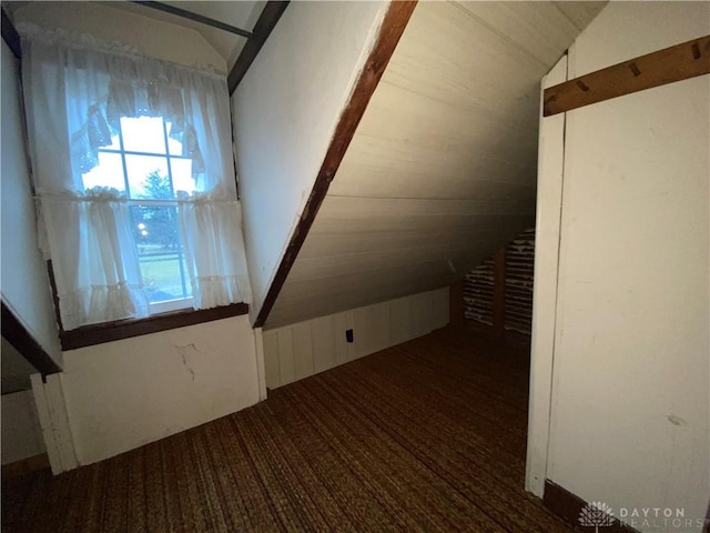 bonus room featuring lofted ceiling and carpet