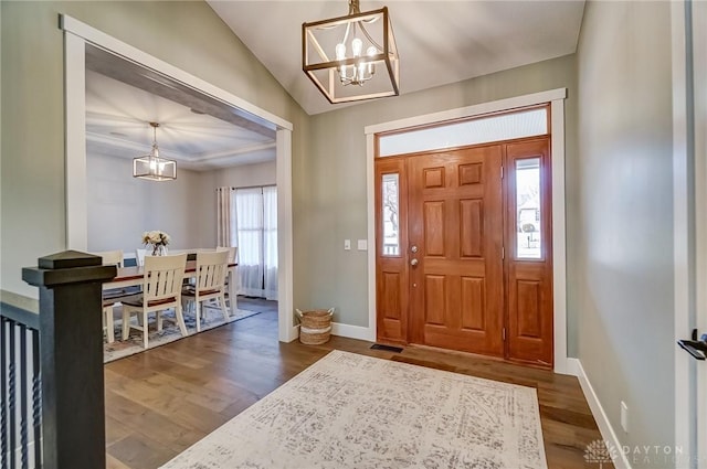 foyer featuring dark hardwood / wood-style flooring and an inviting chandelier