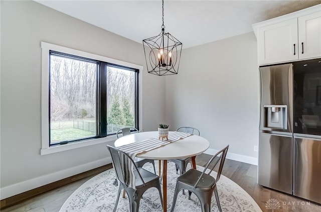 dining room with hardwood / wood-style flooring and a chandelier