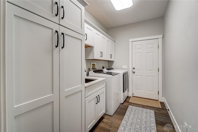 laundry area featuring cabinets, dark hardwood / wood-style floors, and independent washer and dryer