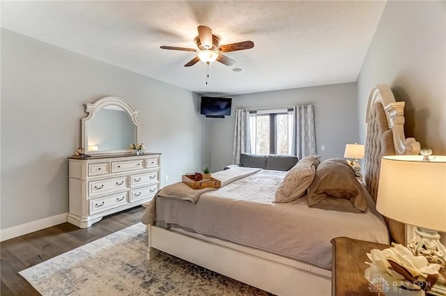 bedroom featuring dark wood-type flooring and ceiling fan