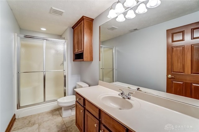 bathroom featuring vanity, a shower with shower door, tile patterned floors, and toilet