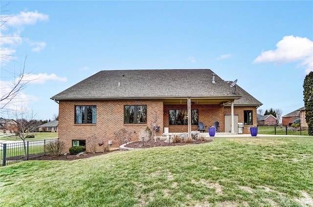 back of property with a patio and a yard