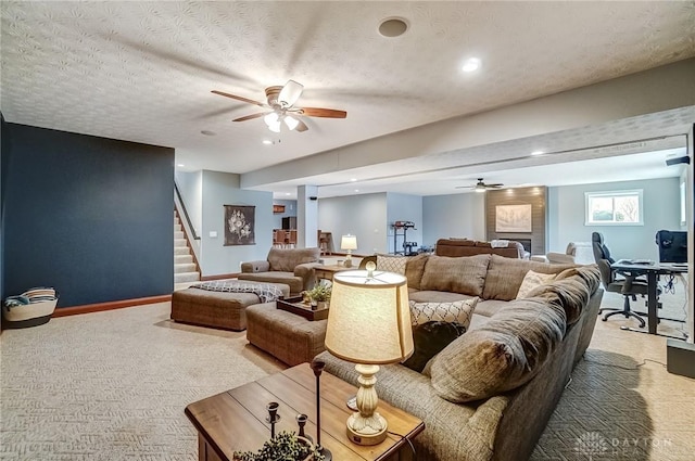 living room with ceiling fan, a textured ceiling, and carpet flooring