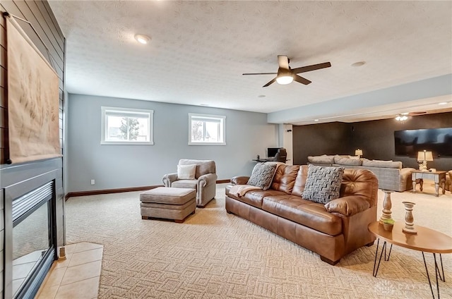 living room featuring a textured ceiling, light colored carpet, and ceiling fan