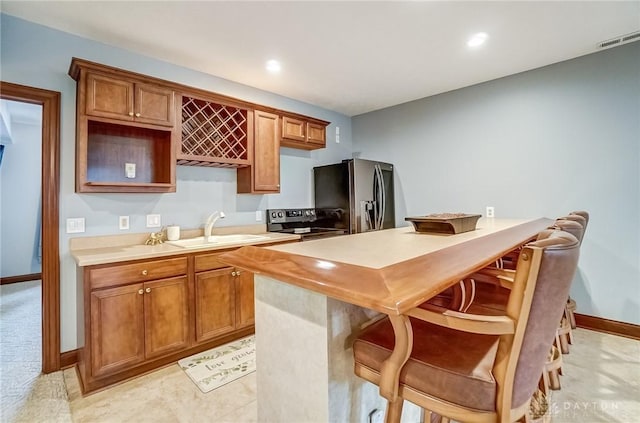 kitchen featuring a kitchen island, appliances with stainless steel finishes, and sink