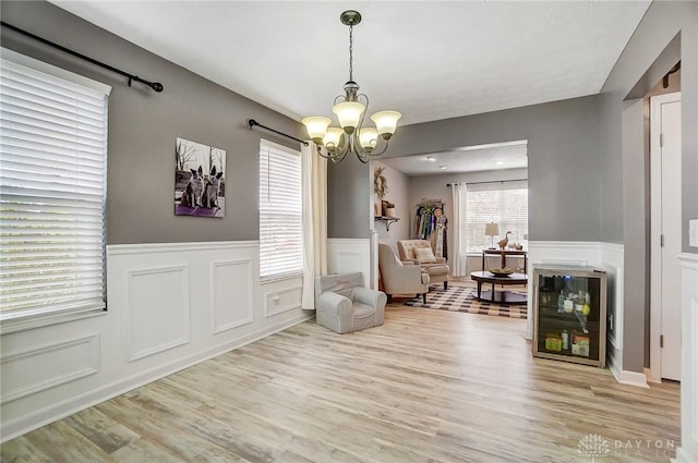 sitting room featuring a chandelier and light wood-type flooring