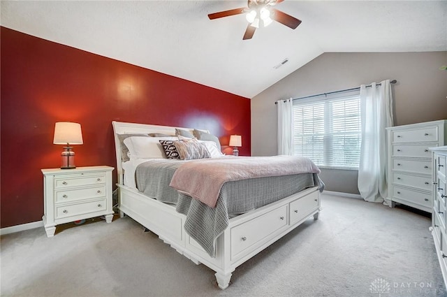 bedroom featuring lofted ceiling, light carpet, and ceiling fan