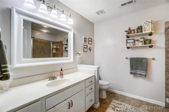 bathroom featuring vanity, a textured ceiling, toilet, and walk in shower