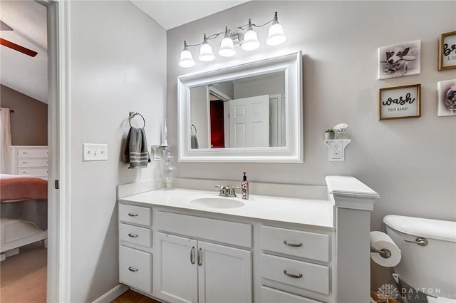 bathroom featuring ceiling fan, vanity, and toilet