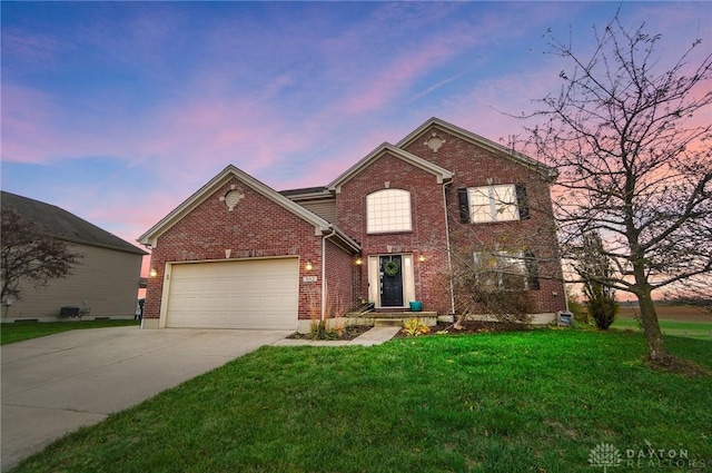 view of property with a garage and a lawn