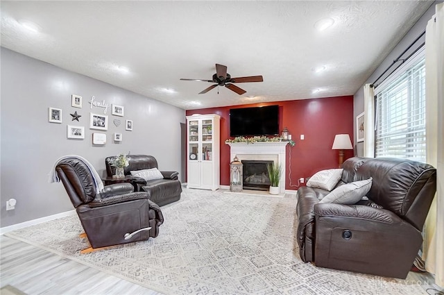 living room featuring a textured ceiling and ceiling fan