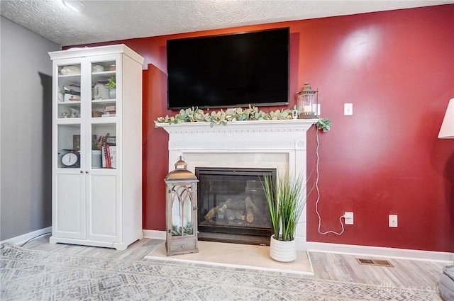 interior space featuring hardwood / wood-style flooring and a textured ceiling