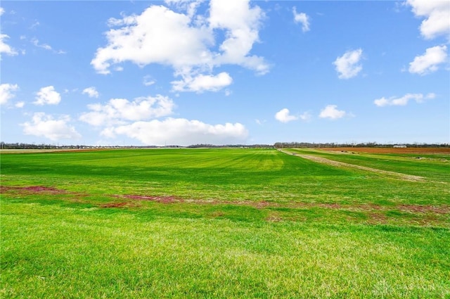 surrounding community featuring a yard and a rural view