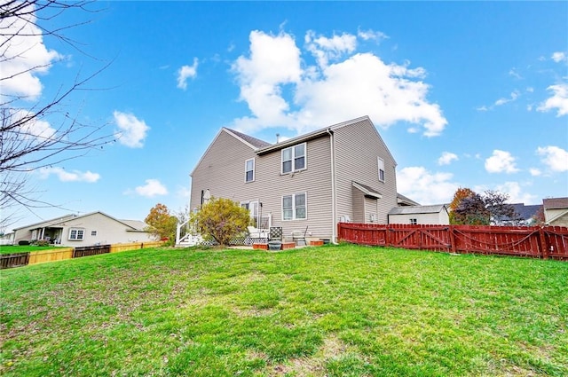 rear view of property featuring a yard