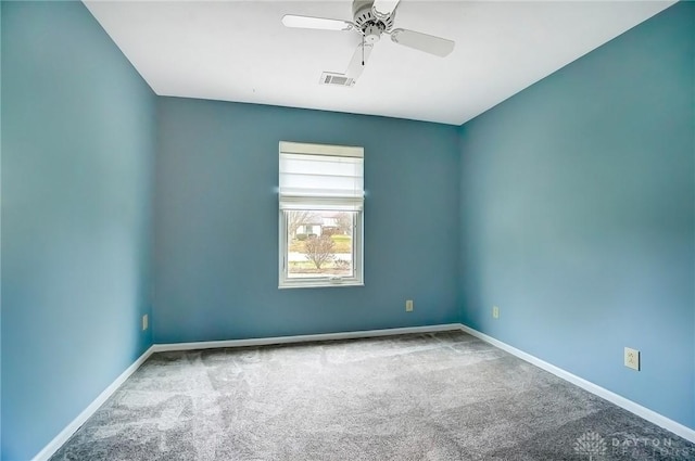 spare room with carpet floors and ceiling fan