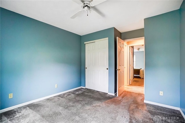 unfurnished bedroom featuring ceiling fan, carpet floors, and a closet