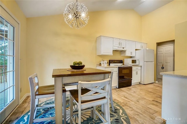 kitchen with white cabinetry, white appliances, light wood-type flooring, and pendant lighting