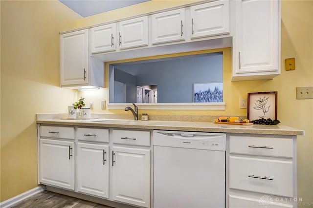 kitchen featuring white dishwasher, sink, dark hardwood / wood-style flooring, and white cabinets