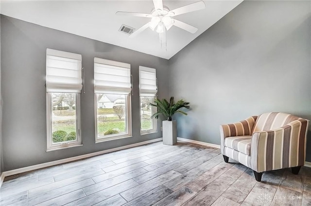 sitting room featuring ceiling fan, lofted ceiling, and light wood-type flooring